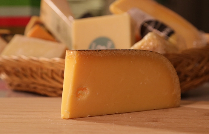 Piece Of Aged Gouda On The Table